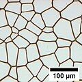 Voronoi tessellation pattern of polygons achieved by the coalescence of dewetting holes.