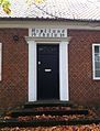 Black door above a set of stairs