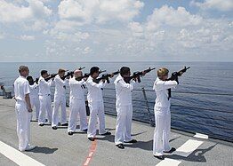 Sailors aboard the USS William P. Lawrence perform a Three-volley salute during a Memorial Day ceremony in honor of Keating.