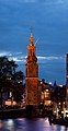 Image 3 Munttoren Photo: Massimo Catarinella The Munttoren, a tower in Amsterdam, the Netherlands, as seen from the river Amstel at dusk. The tower was originally part of the Regulierspoort, one of the main gates in Amsterdam's medieval city wall, dating to 1487. After a fire destroyed the gate in 1618, the tower was rebuilt in the Amsterdam Renaissance style, with an eight-sided top half and open spire designed by Hendrick de Keyser, featuring a clock with four faces and a carillon of bells. The name ("Mint Tower") refers to the time when it was temporarily used to mint coins in the Rampjaar ("disastrous year") of 1672 when both England and France declared war on the Dutch Republic, and silver and gold could not be safely transported to Dordrecht and Enkhuizen, where coins were normally minted. More selected pictures