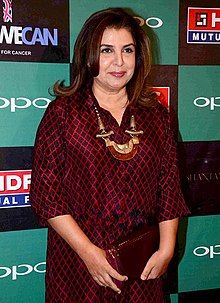 Farah Khan is smiling towards the camera.