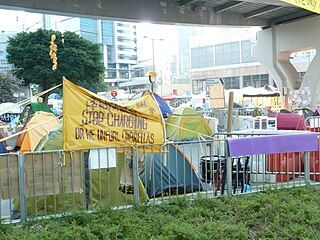 Parody of police banner: "Stop Charging or We Unfurl Umbrellas"