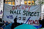 Sign that says "Occupy Wall Street with peace"