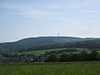 The Hohe Wurzel (with its TV tower) from the west, in the foreground is (in the valley) Wambach, in the foreground is Bärstadt, on the extreme left is the Großer Feldberg