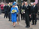 Queen Elizabeth II (centre, in blue) and Prince Philip hold nosegays as they leave Wakefield Cathedral after the 2005 Royal Maundy