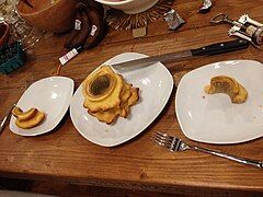 The cake (center) served onto plates (right and left) showing characteristic cake layers resembling growth rings of trees