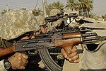 U.S. Army Soldier from the 1st Stryker Brigade Combat Team return fire on insurgents from a rooftop in Buhriz, Iraq