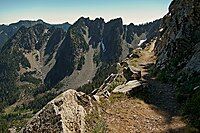 Mountainside trail with view of jagged rocky mountain with steel talus