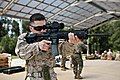 A U.S. Marine armed with an M27 IAR affixed with ACOG Squad Day Optic.