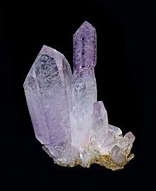 Purple amethyst crystals against a black background