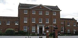 Georgian red-brick 3-storey mansion house with neoclassical pediment