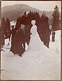 Snowwomen can be as hard to photograph as snowmen. Here two assistants hold up a blanket behind the sculpture to increase the contrast. Photograph circa 1910