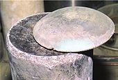 Button of plutonium metal above a calcium chloride salt cake