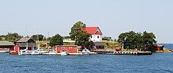 A view of Aspö from the sea. The white building on the top of the hill is the chapel