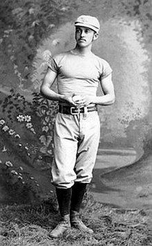 Richmond standing and holding a baseball