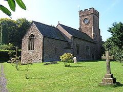 Stone building with square tower.