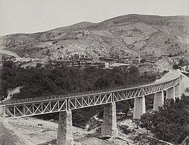 View of a nearby railway bridge showing the village in 1894