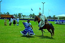 A Chalan in a Paso horse dancing marinera with a lady