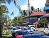 Photograph of a street in Lāhainā, with cars, pedestrians, and historic buildings.