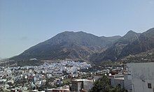 A panoramic view of Chefchaouen town situated within a mountainous area.