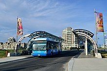 Blue bus at a station