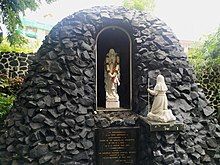 The Church Grotto houses statues of Our Lady of Lourdes and St. Bernadette. It was built in 1954, in commemoration of the first centenary of the declaration of the Dogma of the Immaculate Conception of the Blessed Virgin Mary; it has undergone several structural modifications since.