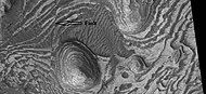 Layers and faults in Firsoff Crater, as seen by HiRISE under HiWish program. Arrows show one large fault, but there are other smaller ones in the picture.