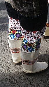 Ceremonial kamik boots worn by women in Greenland during special occasions. Shorter sealskin outer boots are worn over decorated textile thigh-high inners. Sisimiut, Greenland