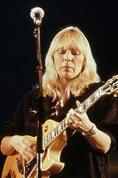 Joni Mitchell, Canadian singer-songwriter, playing a guitar