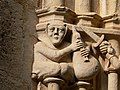 Detail of a figure with bagpipes carved on a capital in the cloister