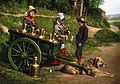 Two Belgian women sell milk from a dogcart, c. 1890-1900. Peddlers played a significant historic role in supplying isolated populations diverse goods. Some carried their wares and others, as here, used a domesticated animal for transport. Early photochrom print.