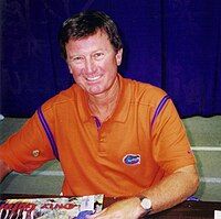 Steve Spurrier, smiling in an orange Gators shirt