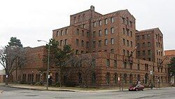 Large brick building on corner with multiple towers