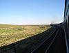 view from a train travelling along the route of the Trans-Aral Railway