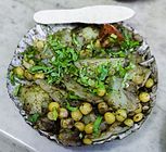 Alu kabli, a Bengali alu chat made with sliced boiled potatoes, chickpeas, tomatoes, cucumbers, tamarind sauce, Bengali spices, chopped chillies and garnished with coriander leaves