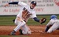 Image 8A shortstop tries to tag out a runner who is sliding head first, attempting to reach second base. (from Baseball)