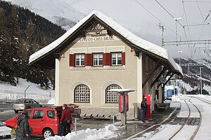 Two-story building with gabled roof next to platforms and tracks