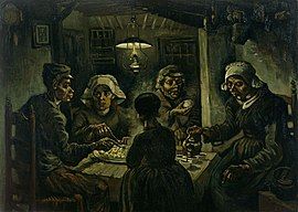 Two men and three women eating potatoes