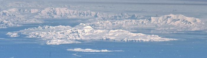 Brabant Island seen from northeast, with the smaller Hoseason Island and Liège Islands in the foreground, and Anvers Island (on the right) and the Antarctic Peninsula in the background. Lecointe Island lies to the left of Brabant Island, separated by a narrow channel (the Pampa Passage) of water.