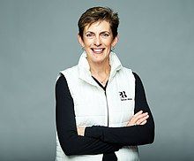 Headshot of Karen Catlin, smiling, wearing a Better Allies® vest.