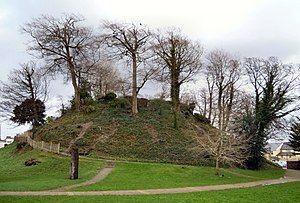 Grass covered mound with steep sides and a path leading up the side.