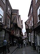 Jettied buildings overhang the street by several feet