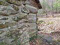 Exterior Chimney and corner detail with a stone retaining wall.