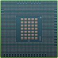 The underside of the 90 nm Cell/B.E. processor showing its 1242 solder balls, each 0.6 mm in diameter, and its array of 35 capacitors