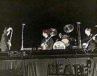 The Beatles performing at the Gator Bowl with Ringo Starr’s drumkit nailed to the stage in 1964.