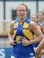 Female athlete in an Australian rules football game