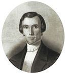 Portrait of clean-shaven man with light shirt and dark formal jacket