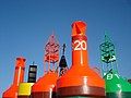 Several different buoys at a storage depot.