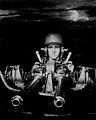 PT boat gunner mans a twin .50 caliber Browning M2 machine gun off New Guinea