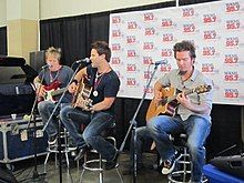 Country music band Parmalee performing on a stage.